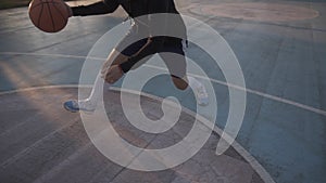 Female basketball player in shorts and white socks on professional court running with ball and successfully thowing ball