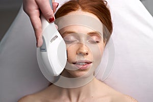 Female beautician doing mechanical face polishing procedure for client photo