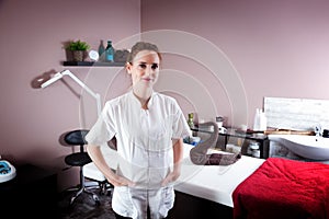 Female beautician in her beauty and massage salon.