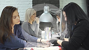Female beauticians do different procedures and services in beauty salon.