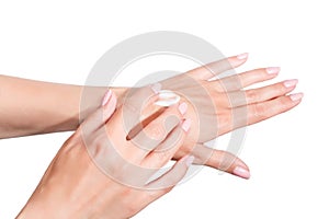 Female beautiful delicate manicured hands with moisturizing cream