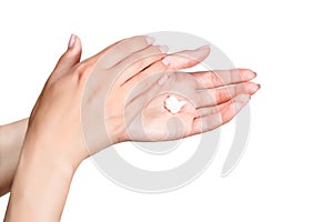 Female beautiful delicate manicured hands with moisturizing cream