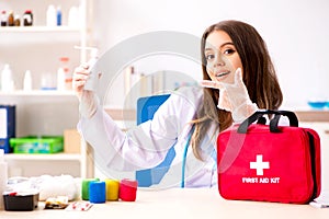 Female beautiful doctor with first aid bag