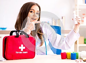 Female beautiful doctor with first aid bag