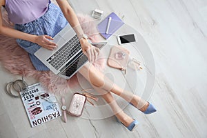 Female beauty blogger with laptop indoors