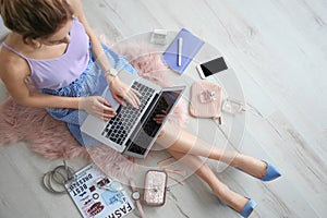 Female beauty blogger with laptop indoors