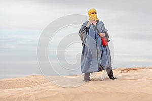 Female in bedouin clothes on dune