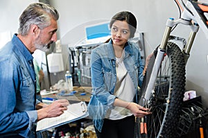 female bicycle mechanic in workshop photo