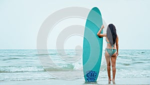 Female in bikini happy playing wave board