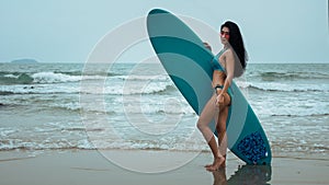 Female in bikini happy playing wave board