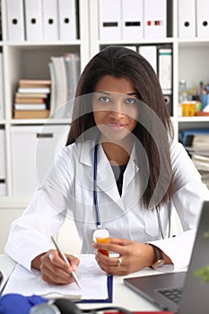 Female black medicine doctor hand hold jar