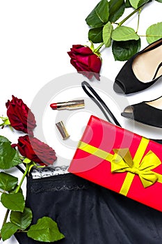 Female black T-shirt jacket with lace, classic shoes, gift box, red lipstick and rose flowers on white background top view flat