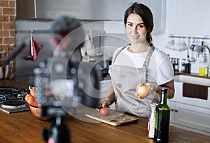Female blogger recording cooking related broadcast at home