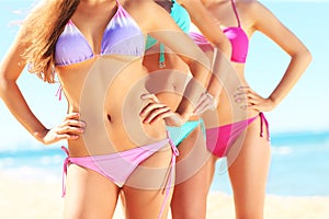 Female bodies in bikini on the beach