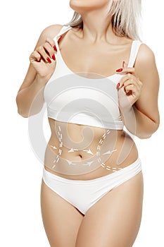 Female body with the drawing arrows. Fat lose, liposuction and cellulite removal concept