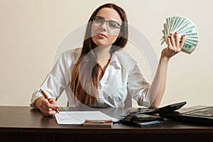 Female bookkeeper holding dollars fan in her hand