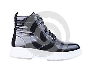 Female boot from black patent leather on a white sole, on a white background.Elegant leather shoes for men and women on a white ba