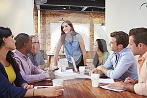 Female Boss Addressing Office Workers At Meeting