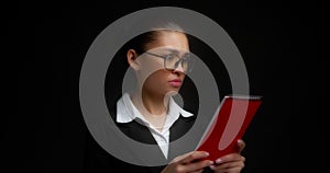 Female boss with a dissatisfied face reads a document,spreads her hands