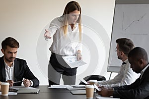 Female boss and employee having conflict during meeting in boardroom photo