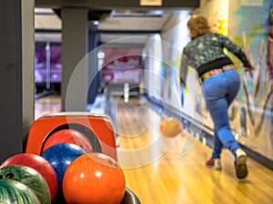 Female bowler throwing bowling ball