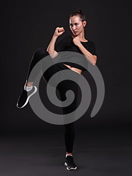 Female boxer posing on black background. Sport concept.