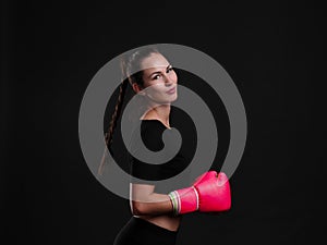 Female boxer posing on black background. Sport concept.