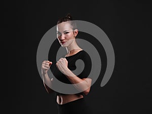 Female boxer posing on black background. Sport concept.