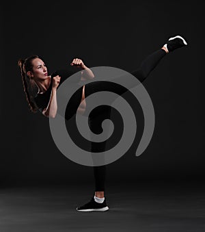 Female boxer posing on black background. Sport concept.