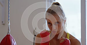 Female boxer practicing boxing in fitness studio 4k