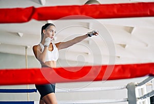 Female boxer practicing her punches at a boxing studio