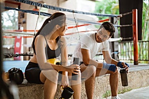 the female boxer sitting and chatting together with the male boxer