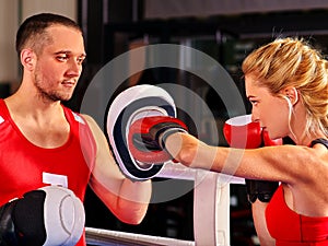 Female boxer throwing right cross at mitts