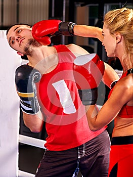 Female boxer throwing right cross at mitts photo