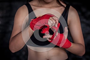 Female boxer wrapping hand and finger for practice