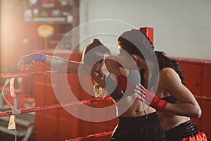 Female boxers fighting in boxing ring