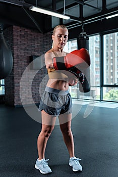 Female boxing trainer getting ready for her work