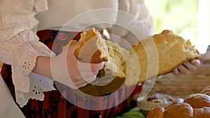 Female Breaking In Half Traditional Baked Bread In Maramures Romania