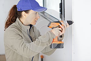 female builder drill wall