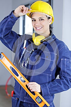 female builder holding spirit level