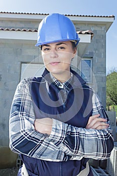 Female builder outside new build property
