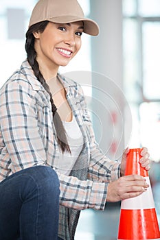 female builder with plastic bollard