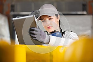 female builder with tablet pc