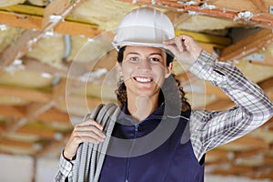 female builder tipping hardhat in greeting