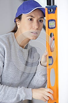 female builder using spirit level
