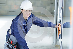 female builder using spirit level
