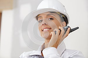 Female builder using walkie talkie
