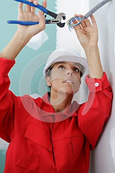 Female builder working with cables