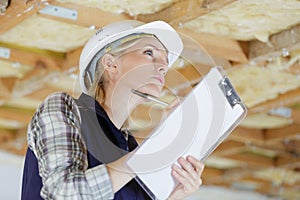 female building inspector holding clipboard