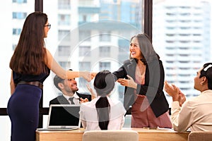 Female business CEO congratulate her female employee for the outstanding achievement of her team performance by shaking hand